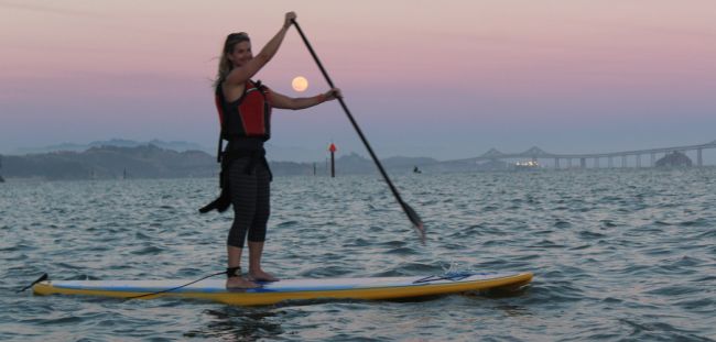 rent a paddleboard and paddle under the full moon