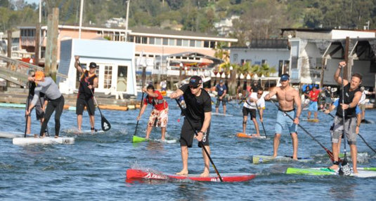 Team Oracle racing Jimmy Spithill leads the paddleboard fleet off the starting line.