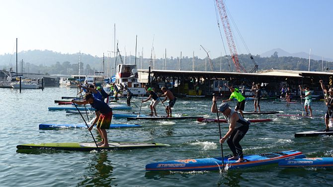 The long course SUP Racers race off the line