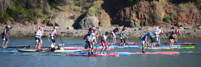 Stand Up paddleboards sprinting off the starting line