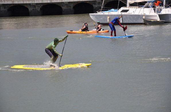 Superman and the Hulk Duking it out for Stand up paddleboard glory