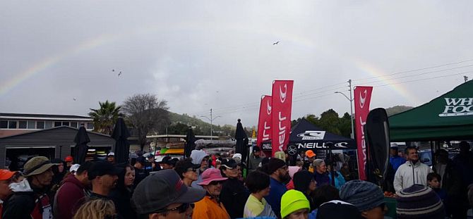 Stand Up Paddleboard racing under rainbows on San Francsico Bay